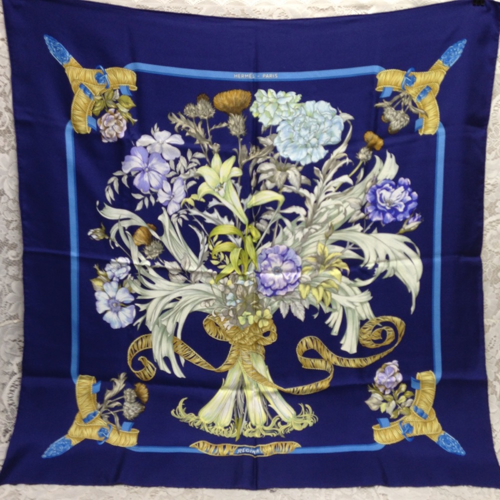 Hermes Regina Floral Scarf over a Blue Backgound